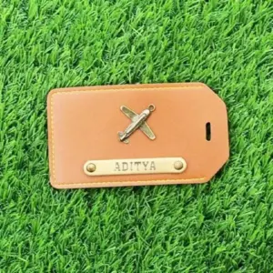 Tan Brown luggage tag attached to suitcase for easy baggage identification during travel