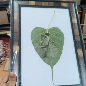 Handcrafted leaf art photo engraving on natural pipal leaf