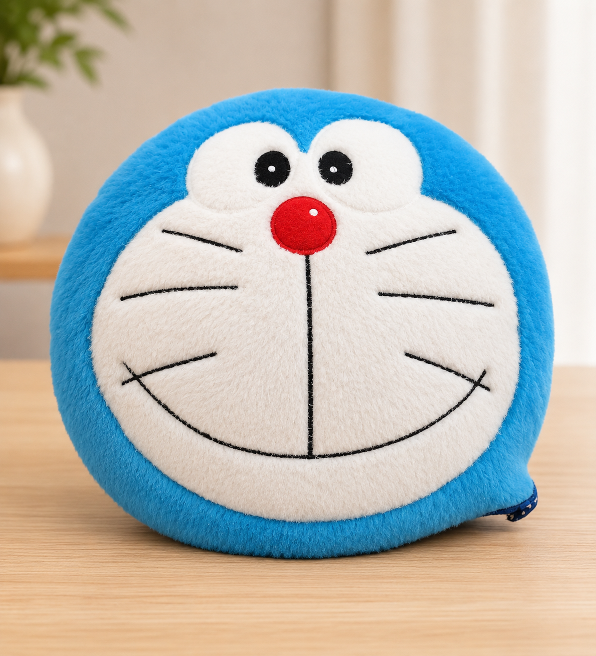 Soft Doraemon face cushion made from plush fabric for kids room decoration and gifting.